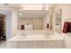 Bathroom featuring a large mirror, a double vanity, and closet access at 2937 S Atlantic Ave # 2001, Daytona Beach, FL 32118