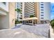 Entrance of high-rise condo building, with covered entrance and manicured tropical landscaping at 2937 S Atlantic Ave # 2001, Daytona Beach, FL 32118