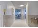Hallway leading to the gym with water fountain and tiled walls at 2937 S Atlantic Ave # 2001, Daytona Beach, FL 32118