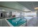 Bright indoor pool with clear water, tiled flooring, and ocean view windows at 2937 S Atlantic Ave # 2001, Daytona Beach, FL 32118
