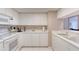 Well-lit kitchen featuring white appliances and a breakfast bar area at 2937 S Atlantic Ave # 2001, Daytona Beach, FL 32118