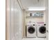 Convenient laundry room with a full-size washer and dryer, plus shelving for storage at 2937 S Atlantic Ave # 2001, Daytona Beach, FL 32118