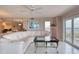Living room featuring a large sofa, water views, and bright decor at 2937 S Atlantic Ave # 2001, Daytona Beach, FL 32118
