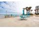 Outdoor pool deck with ocean view, featuring tables, umbrellas and seating areas at 2937 S Atlantic Ave # 2001, Daytona Beach, FL 32118