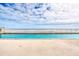 Outdoor pool with ocean view, surrounded by a white fence at 2937 S Atlantic Ave # 2001, Daytona Beach, FL 32118