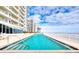 Outdoor pool with ocean view, surrounded by white railing and adjacent to the building at 2937 S Atlantic Ave # 2001, Daytona Beach, FL 32118