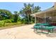A sprawling backyard featuring a green picnic table, perfect for outdoor entertaining at 3119 Mango Tree Dr, Edgewater, FL 32141