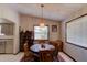 Cozy dining room with a round table and ample natural light from large windows at 3119 Mango Tree Dr, Edgewater, FL 32141