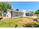 View of the backyard, shed, and screened-in porch offering a serene outdoor retreat at 3119 Mango Tree Dr, Edgewater, FL 32141