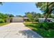 Charming single-story home with an attached garage and long driveway at 3119 Mango Tree Dr, Edgewater, FL 32141
