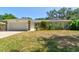 Single-story home featuring an attached garage, and a well manicured lawn at 3119 Mango Tree Dr, Edgewater, FL 32141