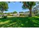 Well-maintained single-story home with a spacious front lawn and mature trees at 3119 Mango Tree Dr, Edgewater, FL 32141