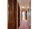 Hallway with wooden closet doors, leading to bedrooms and bathrooms at 3119 Mango Tree Dr, Edgewater, FL 32141