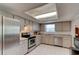 Traditional kitchen featuring stainless steel appliances and tile flooring for easy maintenance at 3119 Mango Tree Dr, Edgewater, FL 32141