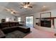 Spacious living room featuring plush seating, a fireplace, and sliding glass doors at 3119 Mango Tree Dr, Edgewater, FL 32141