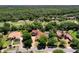 An overhead view of a home with mature trees with a golf course as a scenic backdrop at 3513 Kilgallen Ct, Ormond Beach, FL 32174