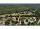 Aerial view of a home with a tile roof and golf course frontage in a lush, green neighborhood at 3513 Kilgallen Ct, Ormond Beach, FL 32174