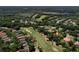 Aerial view of a home with a tile roof, pool, and golf course in a lush neighborhood at 3513 Kilgallen Ct, Ormond Beach, FL 32174