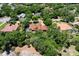Aerial view of a home with a tile roof, pool, and surrounded by lush landscaping and mature trees at 3513 Kilgallen Ct, Ormond Beach, FL 32174