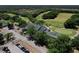 Stunning aerial view of the community clubhouse nestled beside a lush green golf course on a bright sunny day at 3513 Kilgallen Ct, Ormond Beach, FL 32174