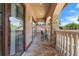 Covered balcony boasts stone pillars and tiled floor with scenic views of neighborhood and roof tops at 3513 Kilgallen Ct, Ormond Beach, FL 32174