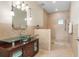 Luxurious bathroom showcasing a glass bowl sink vanity and spacious tiled walk-in shower with modern fixtures at 3513 Kilgallen Ct, Ormond Beach, FL 32174
