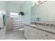Bright bathroom with marble countertops, decorative cabinets, and decorative glass block at 3513 Kilgallen Ct, Ormond Beach, FL 32174