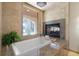 Elegant bathtub features marble countertops and fireplace at 3513 Kilgallen Ct, Ormond Beach, FL 32174