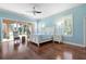 Airy primary bedroom with hardwood floors, a ceiling fan, and a sliding glass door to the patio at 3513 Kilgallen Ct, Ormond Beach, FL 32174