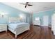 Primary bedroom featuring hardwood floors, light blue walls, and white furniture at 3513 Kilgallen Ct, Ormond Beach, FL 32174