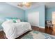 Bedroom with light blue walls, a ceiling fan, wood floors, and a closet at 3513 Kilgallen Ct, Ormond Beach, FL 32174