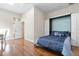 Bedroom with wood floors, a bed with blue bedding, and built in cabinets at 3513 Kilgallen Ct, Ormond Beach, FL 32174