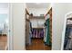 Walk-in closet with wood floor, custom shelving, hanging storage and natural light at 3513 Kilgallen Ct, Ormond Beach, FL 32174