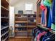 Well-organized closet featuring shelving for shoes and storage, and hanging racks for clothing at 3513 Kilgallen Ct, Ormond Beach, FL 32174