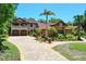 Two-story home boasts an elegant stone driveway, lush landscaping, and a three-car garage at 3513 Kilgallen Ct, Ormond Beach, FL 32174
