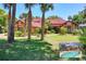 Stunning one-story home with a red tile roof, mature landscaping, and a beautiful lawn at 3513 Kilgallen Ct, Ormond Beach, FL 32174