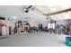 A spacious, cluttered garage with high ceilings and ample storage space at 3513 Kilgallen Ct, Ormond Beach, FL 32174