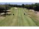 Scenic golf course view with lush green fairways, sand traps, and mature trees on a sunny day at 3513 Kilgallen Ct, Ormond Beach, FL 32174