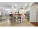 Open kitchen with breakfast bar, white cabinetry, stainless steel appliances, and views of the entryway at 3513 Kilgallen Ct, Ormond Beach, FL 32174