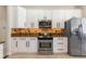 Modern kitchen equipped with stainless steel appliances, white cabinetry, and tiled backsplash at 3513 Kilgallen Ct, Ormond Beach, FL 32174