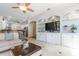 Bright living room featuring built-in shelving, a ceiling fan, and an open layout to the kitchen at 3513 Kilgallen Ct, Ormond Beach, FL 32174