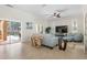 Bright living room features stylish furniture, a modern ceiling fan, and access to the outdoor pool area at 3513 Kilgallen Ct, Ormond Beach, FL 32174