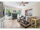 Cozy living room with built-in cabinets, a fireplace, and views of the lush outdoor greenery at 3513 Kilgallen Ct, Ormond Beach, FL 32174