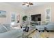 Comfortable living room with cozy seating, a modern fireplace, and views of the outdoor patio at 3513 Kilgallen Ct, Ormond Beach, FL 32174