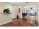 Open concept living space with bar seating area, hardwood floors and a pool table in background at 3513 Kilgallen Ct, Ormond Beach, FL 32174