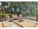 Relaxing screened patio with comfortable seating, lush landscaping, and a tiled floor at 3513 Kilgallen Ct, Ormond Beach, FL 32174