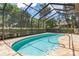 Sparkling pool surrounded by a screened enclosure and a decorative stone patio at 3513 Kilgallen Ct, Ormond Beach, FL 32174