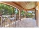 Screened porch with stone tile flooring and a view of lush tropical vegetation at 3513 Kilgallen Ct, Ormond Beach, FL 32174