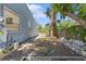 Side view of the backyard with a concrete walkway at 509 Park Dr, Daytona Beach, FL 32114