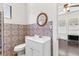 Bathroom featuring a white vanity, round mirror, and vibrant patterned tile accents at 509 Park Dr, Daytona Beach, FL 32114